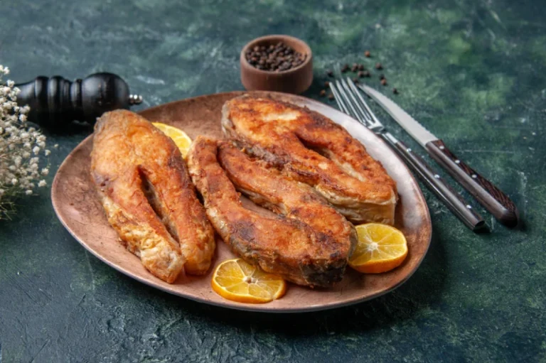 front-close-view-delicious-fried-fishes-lemon-slices-brown-plate-pepper-mix-colors-table-with-free-space